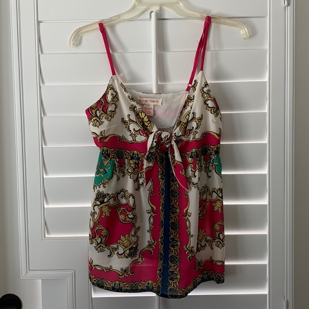 Flirty spaghetti strap top w/ adjustable straps and bow tie in front center
